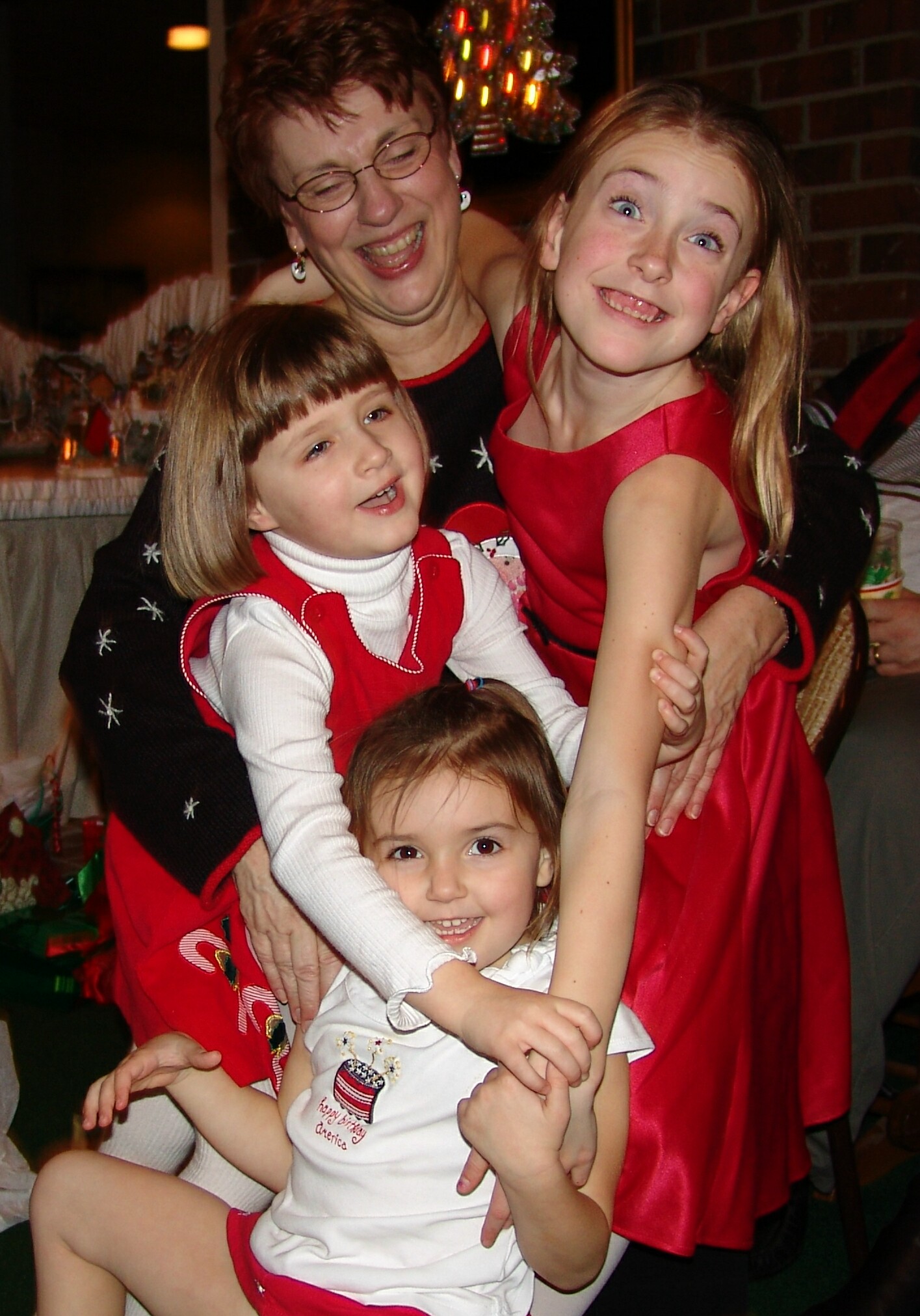 Girls hugging Grandma at Christmas Party